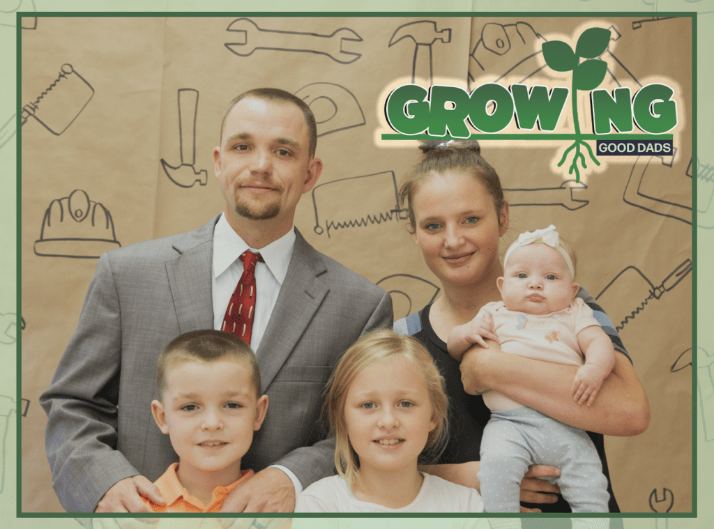 Michael Gray, his wife, and his four kids pose for a family photo during Michael's graduation ceremony from the New Pathways for Good Dads program in November 2022.