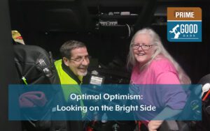 Roy and Renee Romo in their truck. Headline reads, "Optimal Optimism: Looking on the Bright Side."